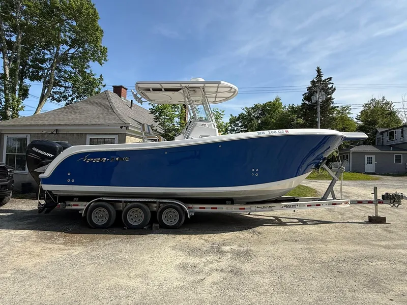 Slide: The Image of 2008 Pro-Line 29 Grand Sport boat on trailer, blue hull, parked outdoors. - 3