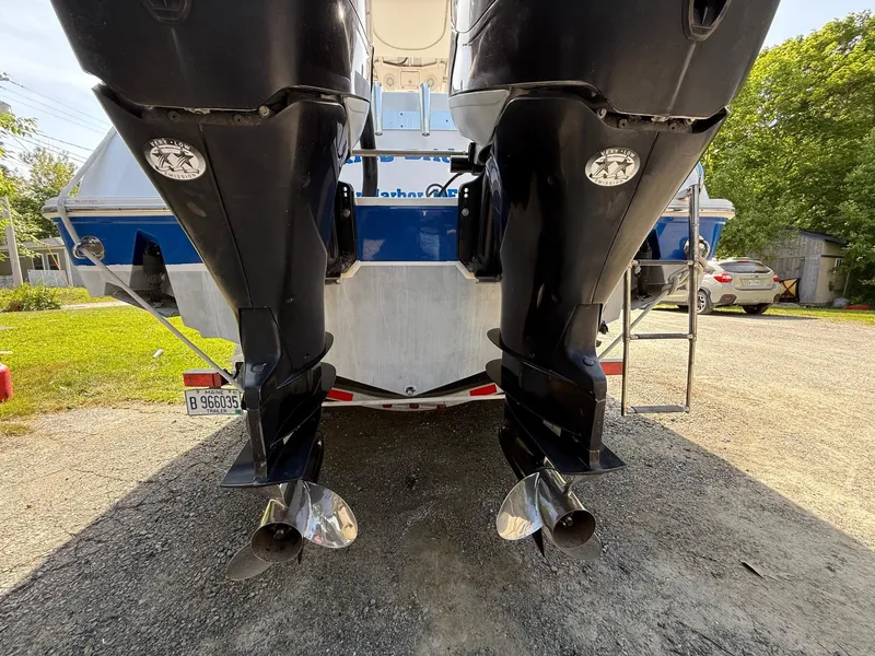 Slide: The Image of 2008 Pro-Line 29 Grand Sport boat with dual outboard motors, parked on a trailer. - 7