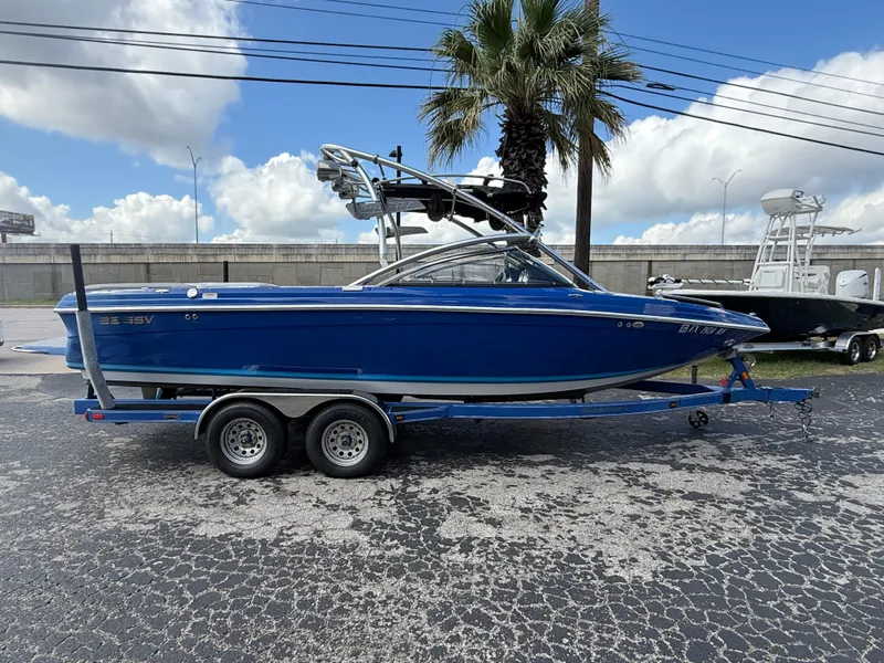 The Image of 2008 Supra Launch 22 SSV boat on trailer, blue exterior, parked outdoors. - 1