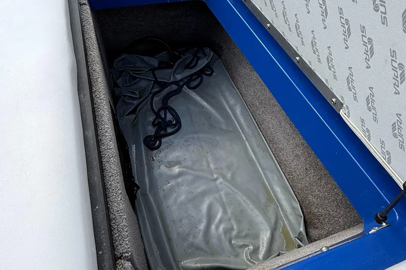 Slide: The Image of Storage compartment of 2008 Supra Launch 22 SSV boat with gray cover and blue interior. - 13