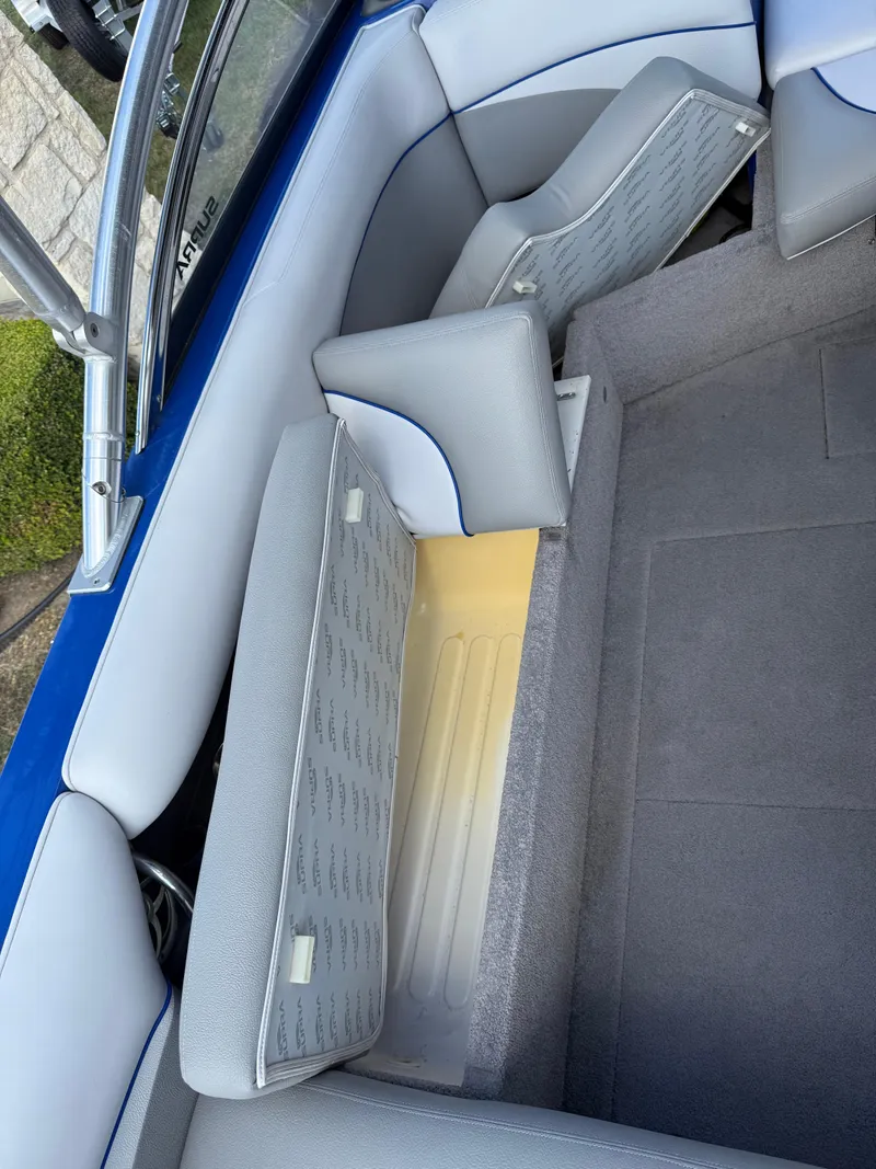 Slide: The Image of 2008 Supra Launch 22 SSV boat interior with open storage compartments and gray seating. - 4