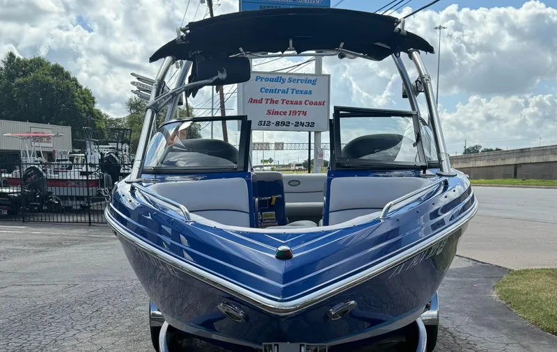 Slide: The Image of 2008 Supra Launch 22 SSV boat in blue, parked outdoors under a cloudy sky. - 5