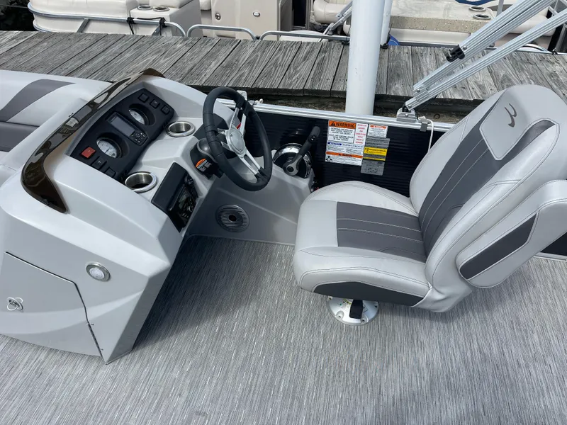 Slide: The Image of 2022 Bennington 21 SX boat interior with steering console and captain's chair. - 10