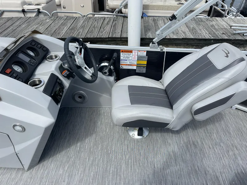 Slide: The Image of Captain's seat and helm of 2022 Bennington 21 SX boat, featuring modern controls and design. - 11