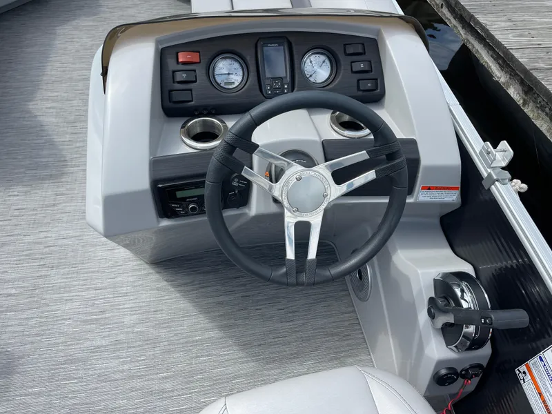 Slide: The Image of Steering console of a 2022 Bennington 21 SX boat with gauges and controls. - 12