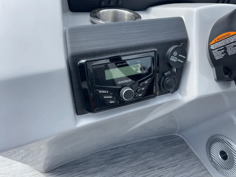 Slide: The Image of 2022 Bennington 21 SX boat dashboard featuring Kicker media center and USB input. - 14