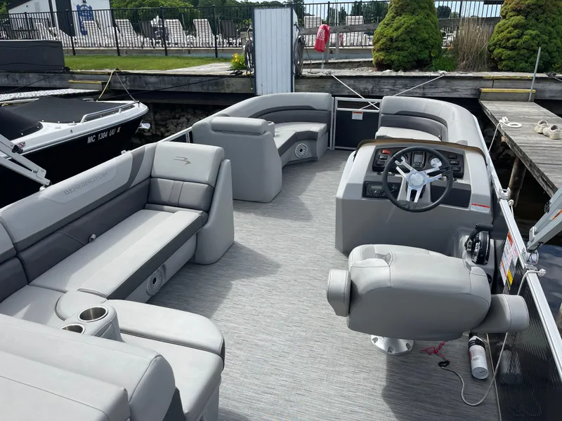 Slide: The Image of 2022 Bennington 21 SX pontoon boat interior with gray seating and steering console. - 16