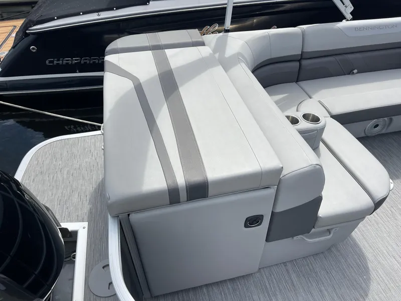 Slide: The Image of 2022 Bennington 21 SX boat interior with gray seating and cup holders. - 19