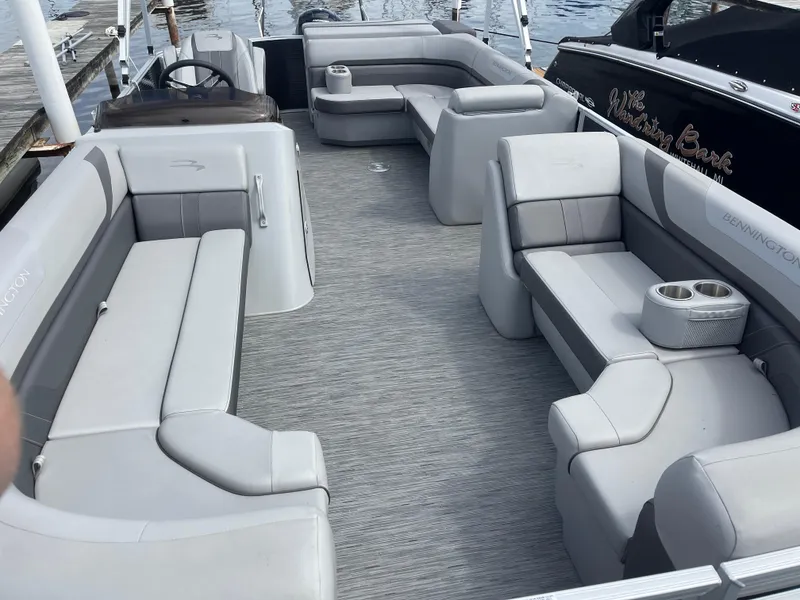 Slide: The Image of 2022 Bennington 21 SX pontoon boat with spacious seating and modern design. - 4