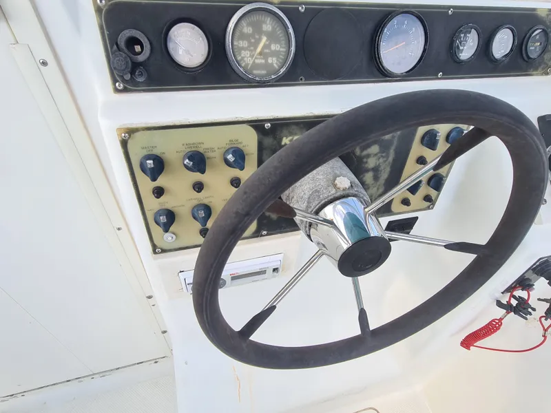 Slide: The Image of Steering wheel and dashboard of 2000 Key West 2300 WA Bluewater boat. - 11