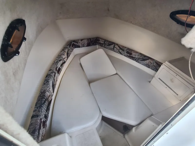 Slide: The Image of Interior cabin of 2000 Key West 2300 WA Bluewater boat with cushioned seating. - 12