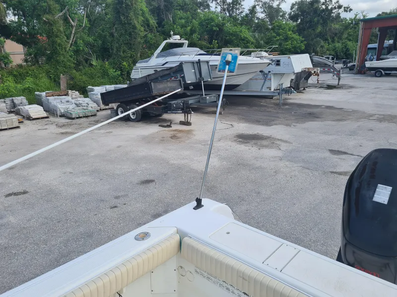 Slide: The Image of Boat yard with Key West 2300 WA Bluewater, 2000 model, surrounded by other boats and trailers. - 19