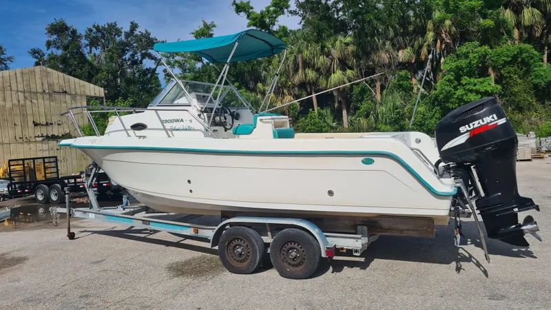 Slide: The Image of 2000 Key West 2300 WA Bluewater boat on trailer with Suzuki outboard motor. - 2