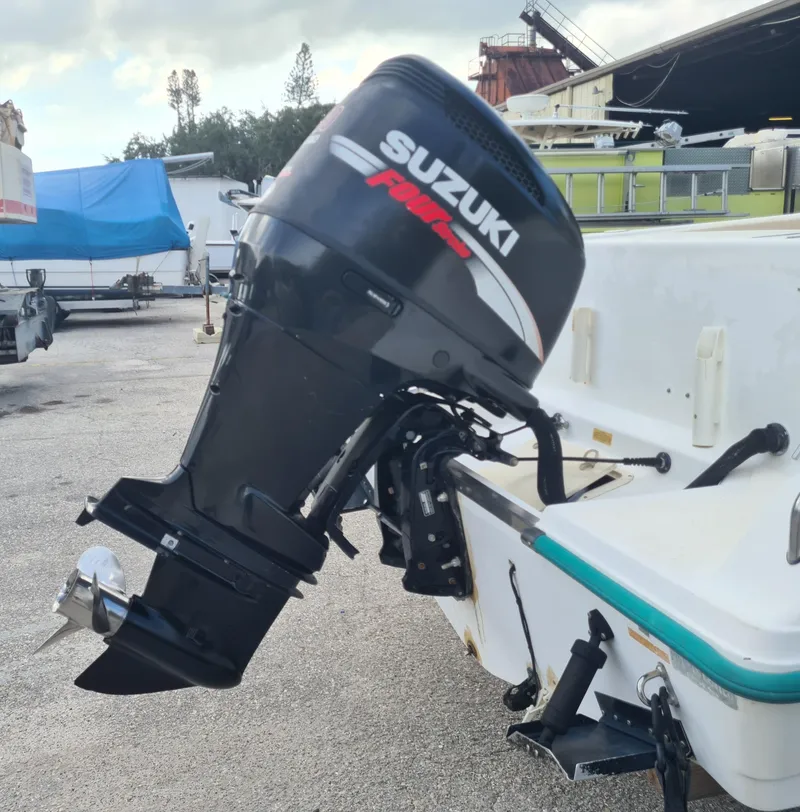 Slide: The Image of Outboard motor on a 2000 Key West 2300 WA Bluewater boat, parked outdoors. - 21