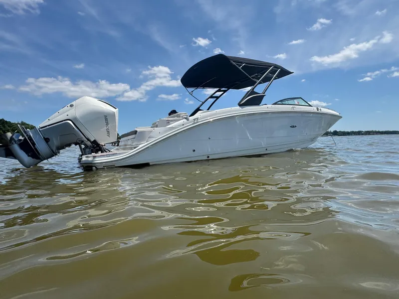 Slide: The Image of 2023 Sea Ray SDX 290 Outboard boat on calm water under a clear blue sky. - 8