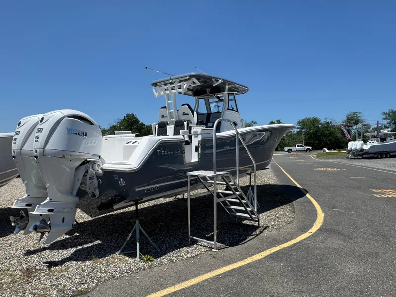 The Image of 2025 Tidewater 302CC boat with dual Yamaha engines on display outdoors. - 1