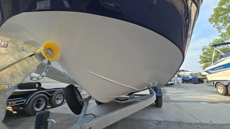 Slide: The Image of 2022 Hurricane SunDeck 191 OB boat on trailer, close-up of hull and winch. - 10