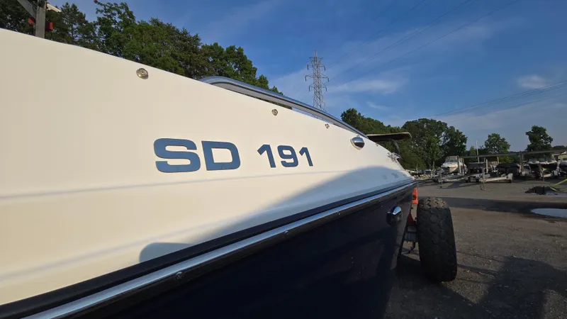 Slide: The Image of 2022 Hurricane SunDeck 191 OB boat parked outdoors on a sunny day. - 12