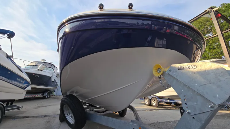 Slide: The Image of 2022 Hurricane SunDeck 191 OB boat on trailer, parked outdoors, clear sky background. - 13