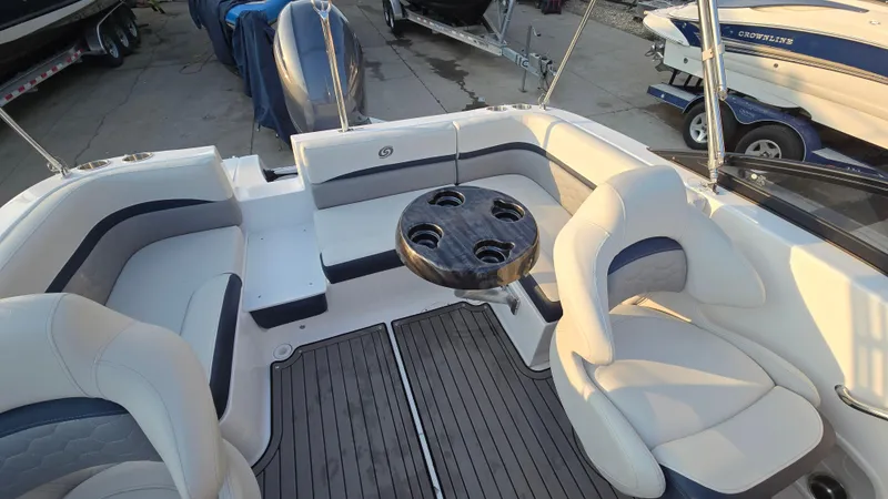 Slide: The Image of 2022 Hurricane SunDeck 191 OB boat interior with seating and table, docked at marina. - 23