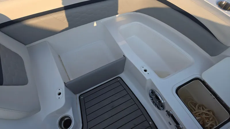 Slide: The Image of 2022 Hurricane SunDeck 191 OB boat interior with seating, storage compartments, and speaker. - 25