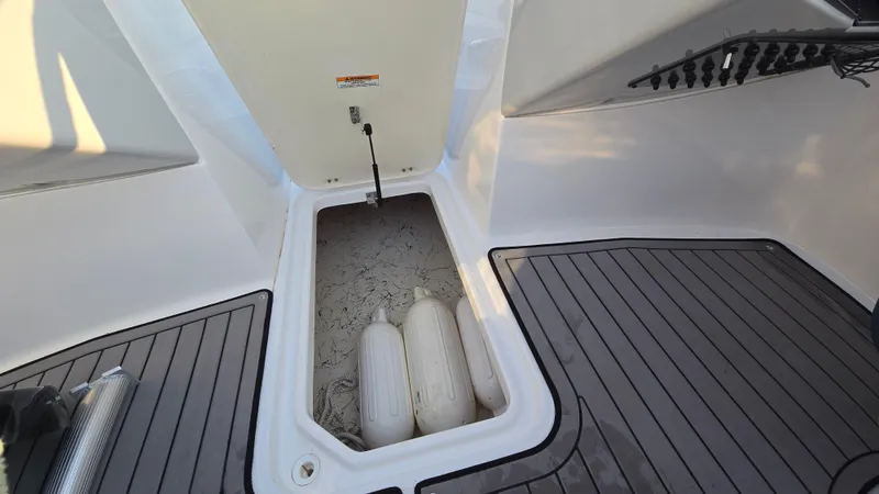 Slide: The Image of 2022 Hurricane SunDeck 191 OB boat storage compartment with fenders and non-slip flooring. - 28