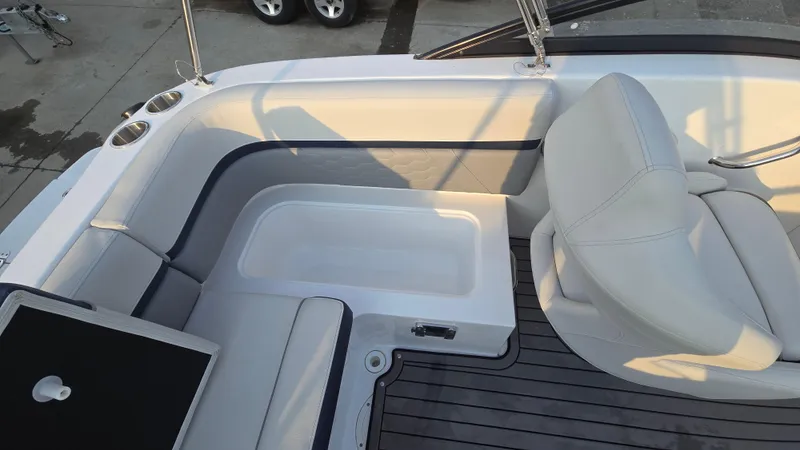 Slide: The Image of Interior of 2022 Hurricane SunDeck 191 OB boat with white seating and cup holders. - 29