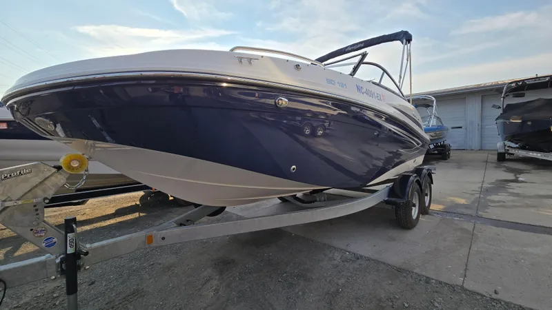 Slide: The Image of 2022 Hurricane SunDeck 191 OB boat on trailer, parked outdoors under a clear sky. - 3