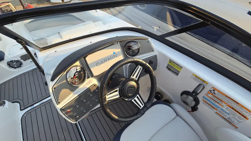 Slide: The Image of 2022 Hurricane SunDeck 191 OB boat dashboard with Garmin navigation system and steering wheel. - 30