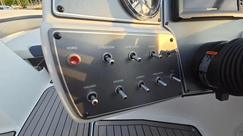 Slide: The Image of Control panel of 2022 Hurricane SunDeck 191 OB boat with various switches and labels. - 35