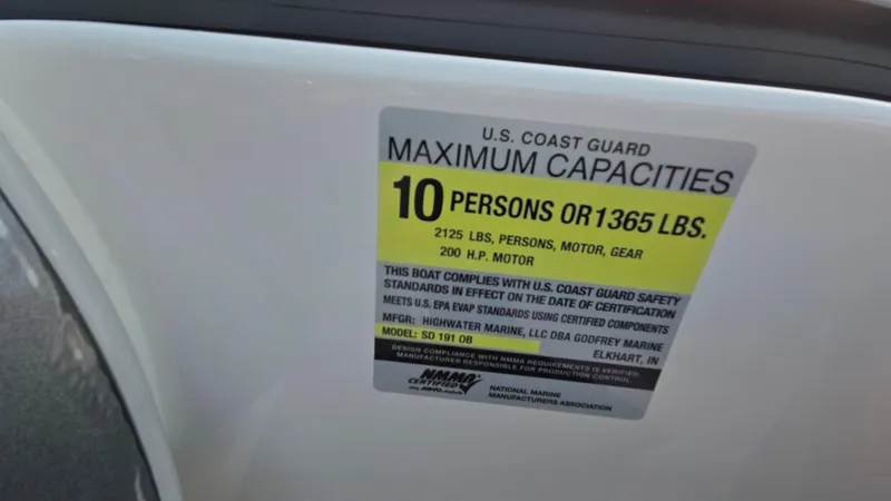 Slide: The Image of U.S. Coast Guard capacity label on 2022 Hurricane SunDeck 191 OB boat, 10 persons or 1365 lbs. - 44