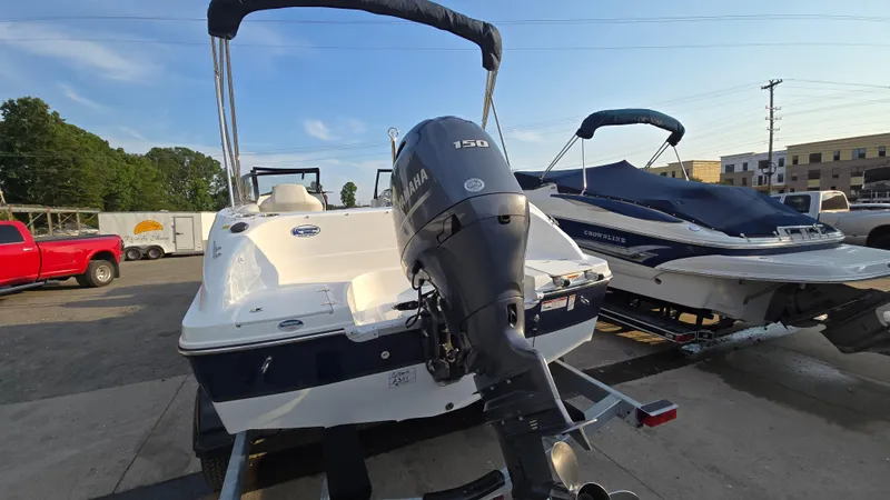 Slide: The Image of 2022 Hurricane SunDeck 191 OB boat with Yamaha 150 engine, parked outdoors. - 7