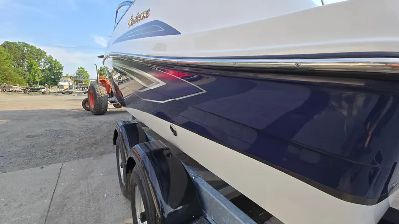 Slide: The Image of 2022 Hurricane SunDeck 191 OB boat on trailer, side view, outdoors. - 8