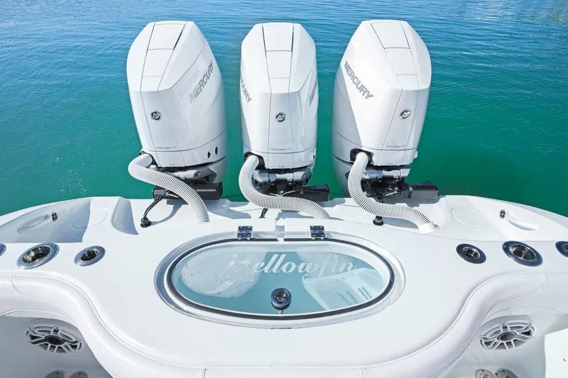 Slide: The Image of 2026 Yellowfin 36 Offshore boat with triple Mercury engines on clear water. - 16