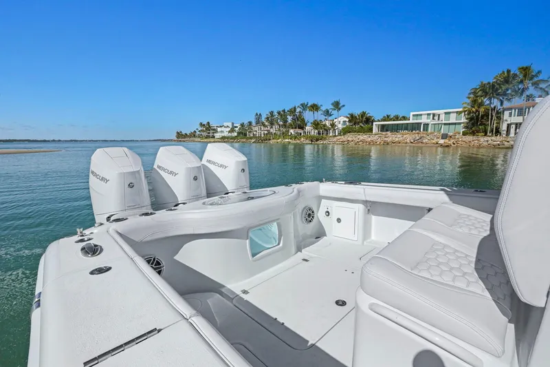 Slide: The Image of 2026 Yellowfin 36 Offshore boat with triple Mercury engines, near luxury waterfront homes. - 21