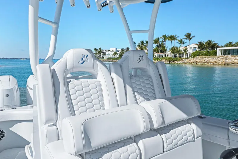 Slide: The Image of 2026 Yellowfin 36 Offshore boat interior with luxurious white seating by the water. - 25