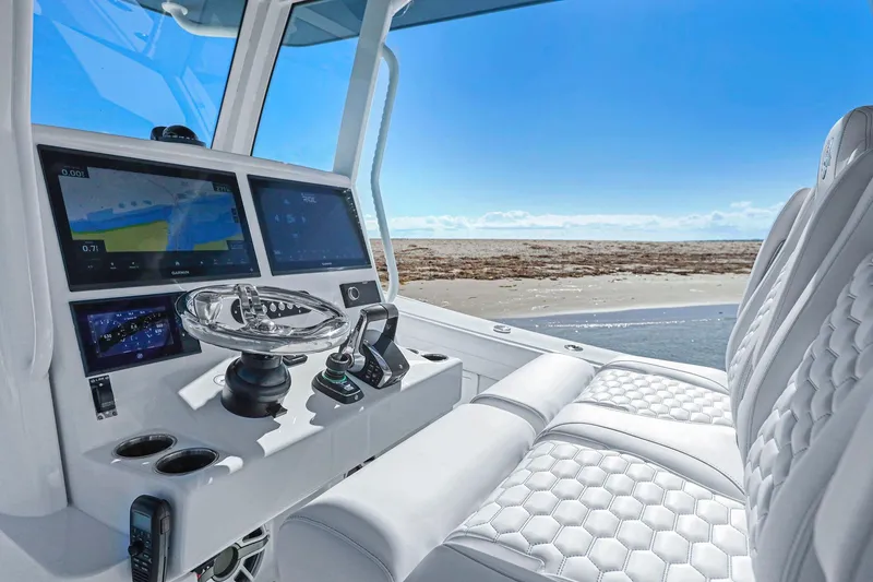 Slide: The Image of 2026 Yellowfin 36 Offshore boat cockpit with advanced navigation system and luxurious seating. - 26