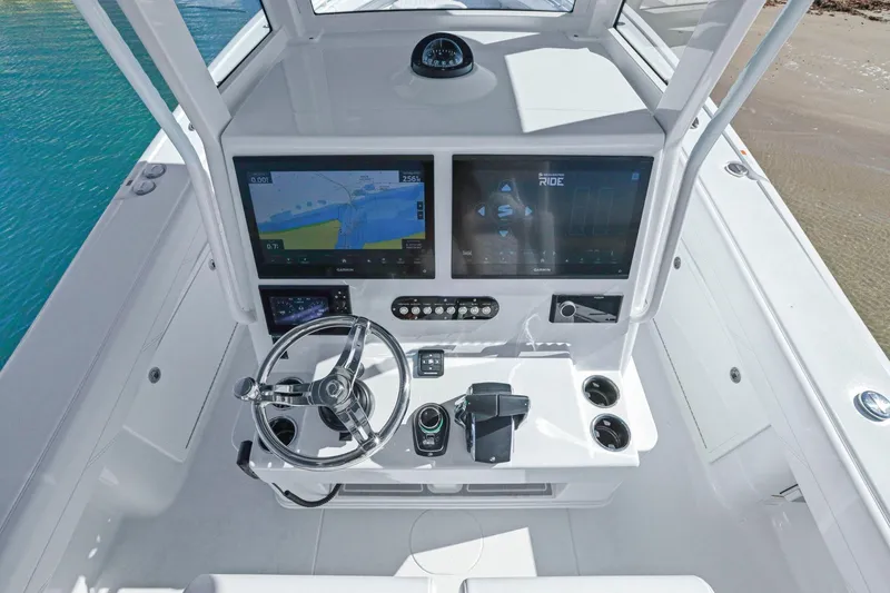 Slide: The Image of 2026 Yellowfin 36 Offshore boat helm with dual screens and modern controls. - 27