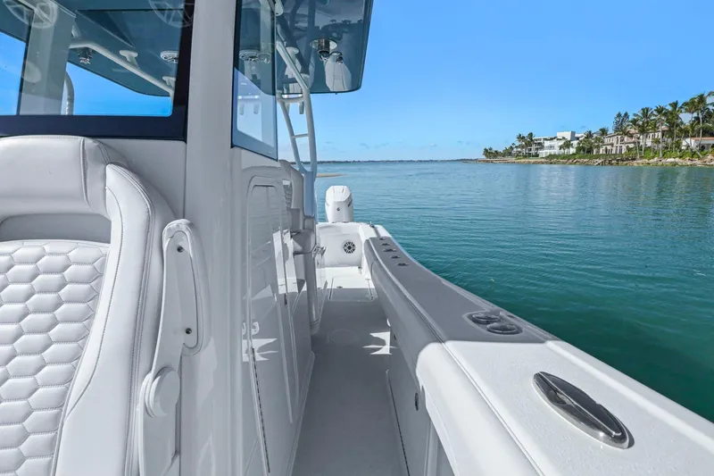 Slide: The Image of 2026 Yellowfin 36 Offshore boat interior with luxurious seating, cruising on calm waters. - 30