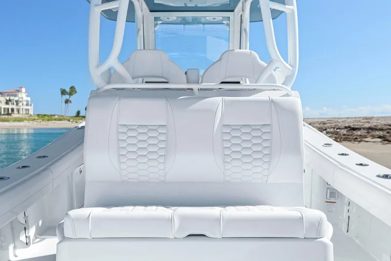 Slide: The Image of 2026 Yellowfin 36 Offshore boat interior with white seating, ocean view, and clear sky. - 33