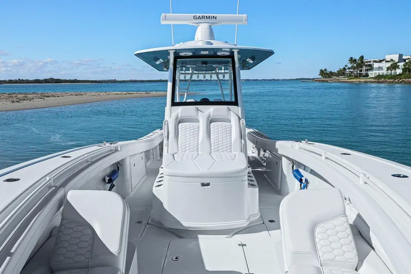 Slide: The Image of 2026 Yellowfin 36 Offshore boat on calm blue water, featuring luxurious seating and Garmin equipment. - 34