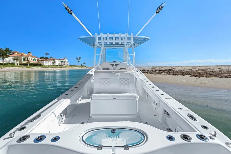 Slide: The Image of 2026 Yellowfin 36 Offshore boat docked on a sunny beach with clear blue skies. - 35
