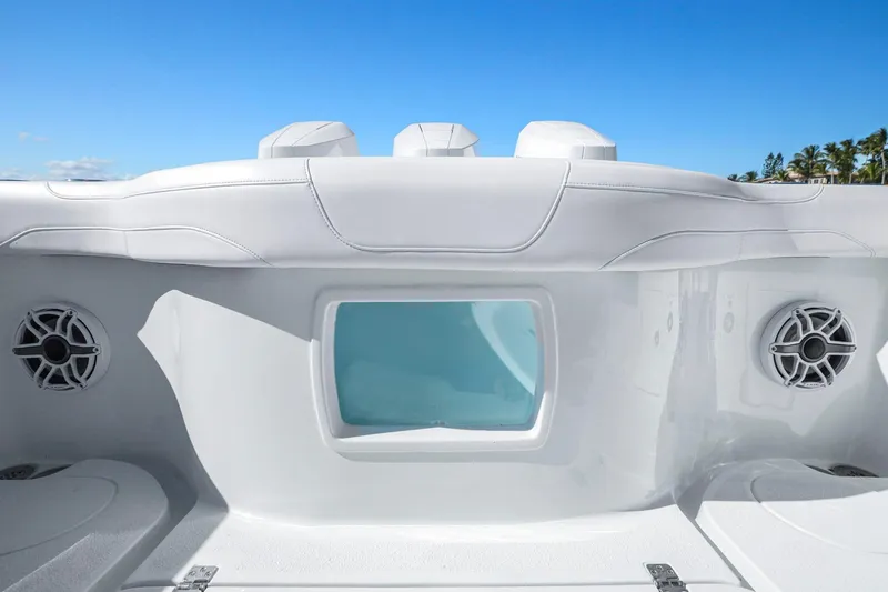 Slide: The Image of 2026 Yellowfin 36 Offshore boat interior with speakers and seating under clear blue sky. - 39