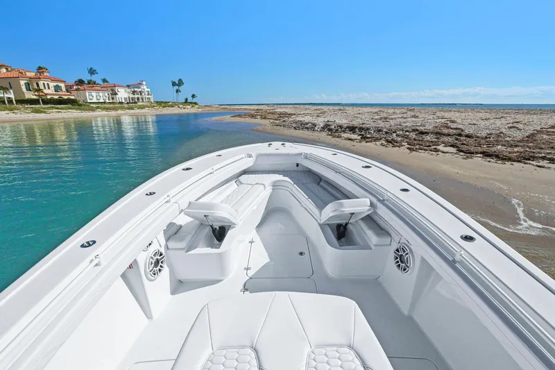 Slide: The Image of 2026 Yellowfin 36 Offshore boat docked on a sandy beach with clear blue water. - 41