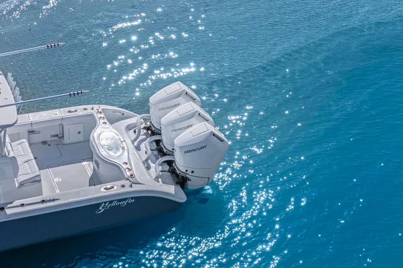 Slide: The Image of 2026 Yellowfin 36 Offshore boat with triple Mercury engines on sparkling blue water. - 43