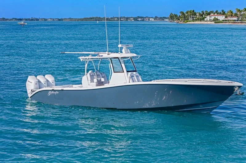 Slide: The Image of 2026 Yellowfin 36 Offshore boat on clear blue water near a tropical shoreline. - 46