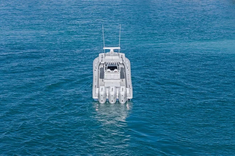 Slide: The Image of 2026 Yellowfin 36 Offshore boat on open blue water, rear view. - 51