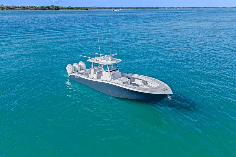 Slide: The Image of 2026 Yellowfin 36 Offshore boat on clear blue water, showcasing sleek design and powerful engines. - 53