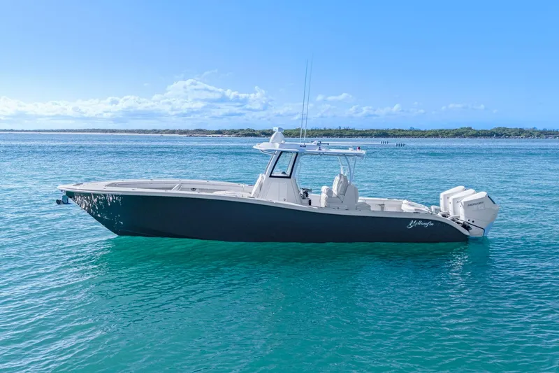 Slide: The Image of 2026 Yellowfin 36 Offshore boat on clear blue water, side view. - 54