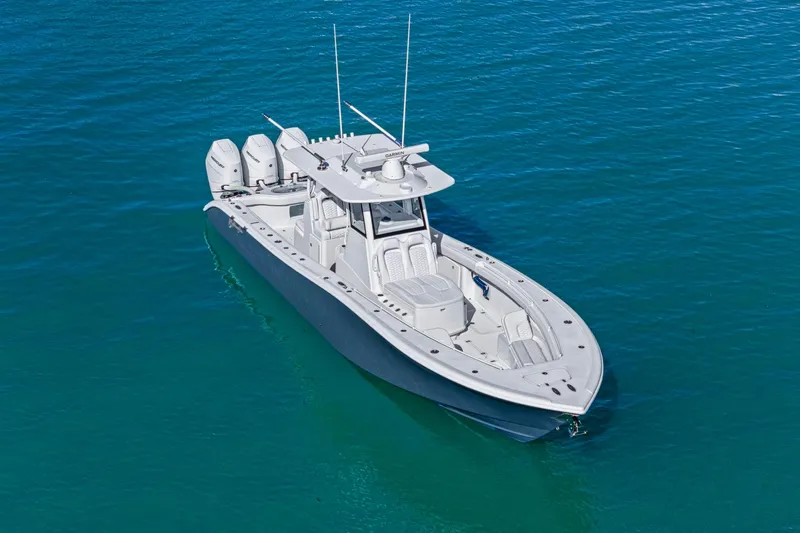 Slide: The Image of 2026 Yellowfin 36 Offshore boat on clear blue water, showcasing sleek design and triple engines. - 58